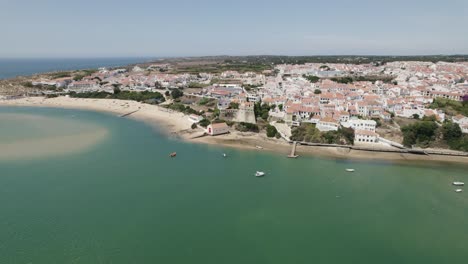 Birds-eye-view-over-coastal-beach-along-Mira-river-at-Vila-Nova-de-Milfontes-in-Portugal