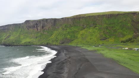 Vik,-Iceland-with-black-sand-beach-with-drone-video-moving-down