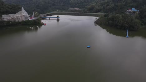 Aerial-view-of-the-Sermo-reservoir-in-the-late-afternoon,-the-largest-reservoir-in-Yogyakarta-and-the-best-tourist-destination-in-the-city