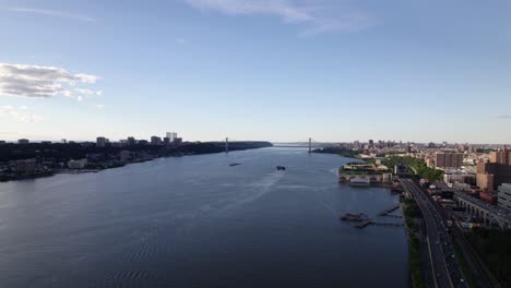 Aerial-view-towards-the-George-Washington-Bridge,-in-sunny-Upper-Manhattan,-NYC,-USA