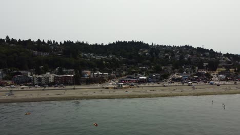 Drone-shot-of-people-enjoying-the-beach-in-the-Seattle-suburb-of-Alki-on-a-smoky-day