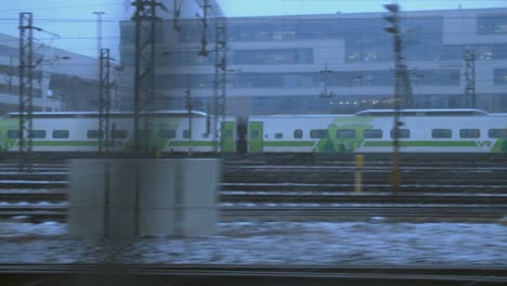 POV-between-two-moving-trains-on-urban-multiline-railway,-with-zoom