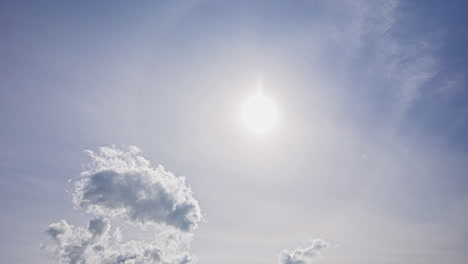 A-sun-halo-is-visible-as-cirrus-clouds-form-in-the-sky-in-the-hot-sunny-atmosphere---time-lapse
