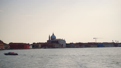 Venetian-Lagoon-With-Church-Of-The-Most-Holy-Redeemer-In-Background,-Venice,-Italy---wide