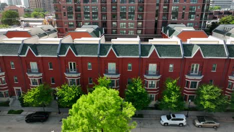 Aerial-truck-shot-of-red-apartment-building-rowhome-houses-in-urban-American-city