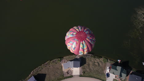Aerial-View-of-Hot-Air-Balloon-Above-Lake-and-Landscape-of-Pagosa-Springs,-Colorado-USA