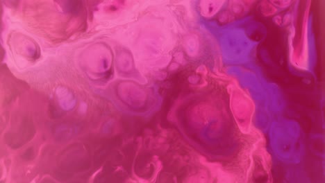 Top-shot-of-red-and-purple-psychedelic-paint-colors-moving-on-a-water-surface-creating-a-living-background