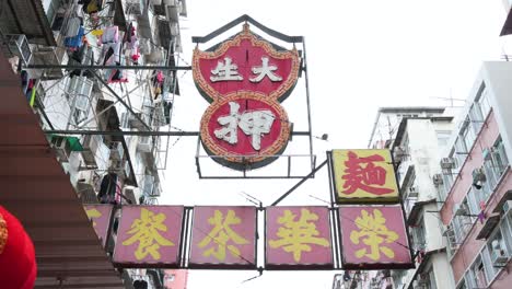 A-pawn-shop-neon-sign-hangs-from-a-facade-of-a-residential-building-in-Hong-Kong