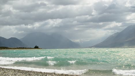Sunny-Lake-Ohau,-New-Zealand-underneath-heavy-storm-clouds