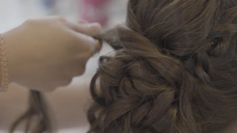Bridal-preparations-hairdresser-straightening-bride's-hair