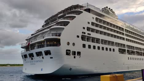 A-huge-Cruise-ship-docking-slowly-on-cruise-port-pier-video-background-|-Luxury-cruise-ship-docking-and-moving-back-slowly-video-background-in-4K