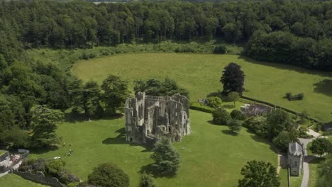 Old-Wardour-Castle-ruins-surrounded-by-bright-green-fields-and-forest