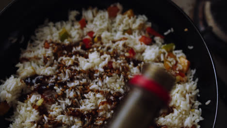 Chef-putting-soy-sauce-for-cooking-fried-rice-in-a-pan