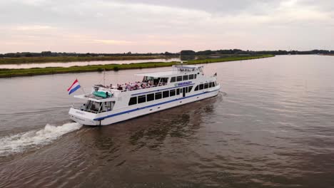 Drone-View-Of-Smaragd1-Party-ship-Going-Past-On-River-Noord