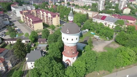 Aerial-rotation-view-of-water-tower-Waterdrop-museum-in-Elk,-Poland