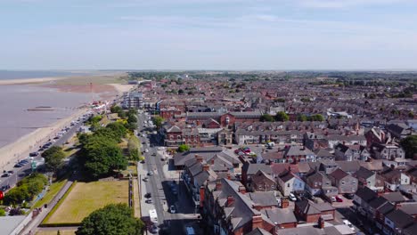 Aerial-view-orbit-above-Grimsby-Cleethorpes-suburban-holiday-town-seafront-property-coastline