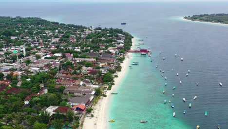 aerial-of-Gili-Trawangan-Island-with-tropical-white-sand-beach-and-boats-anchored-in-turquoise-water