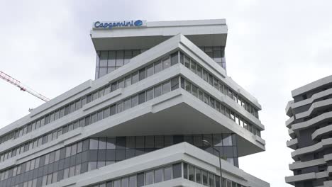 Left-pan,-upper-part-of-Capgemini-147-building-with-logo,-low-angle-shot