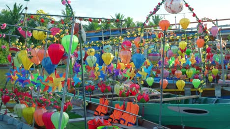 A-stationary-footage-of-small-passenger-boats-with-colorful-lanterns-and-pinwheels-that-are-parked-on-their-docking-area-and-are-ready-for-rental-by-locals-and-tourists