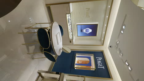 Vertical-Shot-Of-Piaget-Luxury-Watch-Store-Interior---Opulent-Showroom-With-Gleaming-Glass-Cases-Displaying-Beautiful-Timepieces-In-An-Upscale-Ambiance
