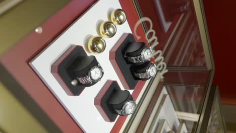 Vertical-Shot-Of-Cartier-Ladies'-Watches-Display-In-Luxurious-Jeweler-Shop