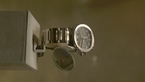 Vertical-View-Of-A-Luxurious-Wrist-Watch-On-The-Store-Counter