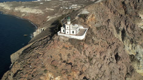 Aerial-View-of-Lighthouse-on-Santorini-Island-Coast,-Greece,-Drone-Shot