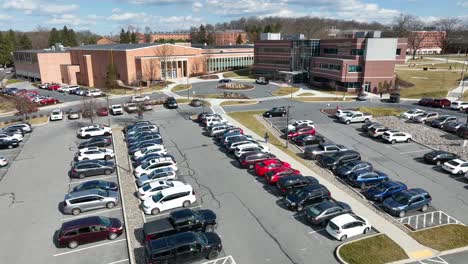 Aerial-shot-of-parking-lot-at-college-building-on-university-campus