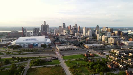 Aerial-backwards-shot,-downtown-Detroit-with-comercia-baseball-park-and-Ford-football-indoor-field