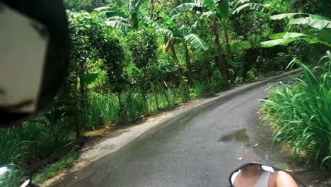 Driving-on-wet-tropical-forest-road,-Nusa-Penida,-Bali-on-motorbike,-Passenger-POV