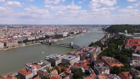 Aerial-view-of-Szechenyi-Chain-Bridge-crossing-Danube-river-between-Pest-and-Buda,-Aerial-cityscape-of-Budapest