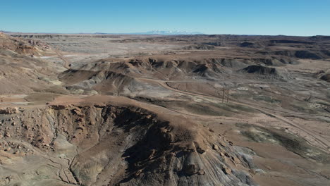 Aerial-View-of-Utah-Desert,-Dirt-Road-and-Sandstone-Hills,-Drone-Shot