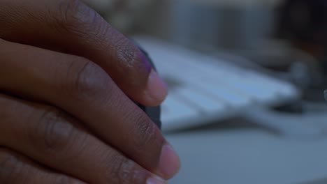 Man-fingers-clicking-and-rolling-computer-mouse---close-up