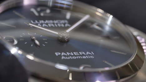 Finger-In-Black-Glove-Touching-Glass-Face-Of-Bold-And-Iconic-Luxury-Watch-Panerai-Luminor-Marina