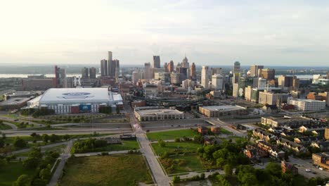 Static-Aerial-shot-of-Urban-city-meeting-green-parks-in-downtown-Detroit-with-a-Ford-indoor-football-field-next-to-Comerica-baseball-park