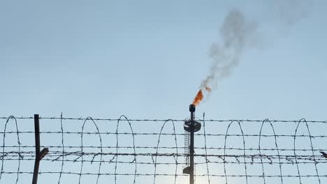 gas-power-plant-burning-with-a-barbed-wire-fence-in-the-foreground-in-Bangladesh