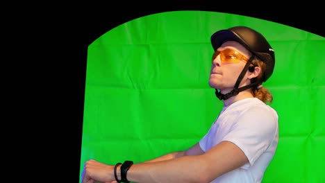 man-in-helmet-and-yellow-glasses-riding-a-bike-and-talking---greenscreen-person