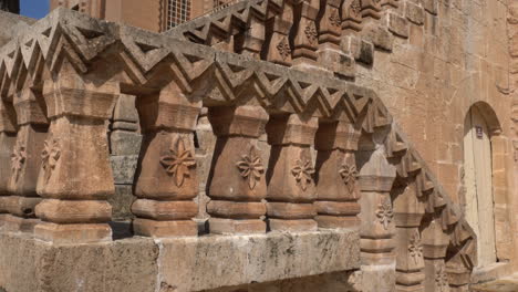 The-camera-sees-the-magnificent-building-of-the-Mor-Behnam-Church,-one-of-the-most-important-church-of-Mardin,-and-the-magnificent-stone-staircase-in-front-of-it,-tilting-it-from-the-bottom-up
