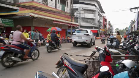 Nan-Province,-Thailand---November-22,-2022:-Shot-of-locals-coming-out-after-shopping-from-a-local-market-in-Nan-city,-Thailand-during-morning-time
