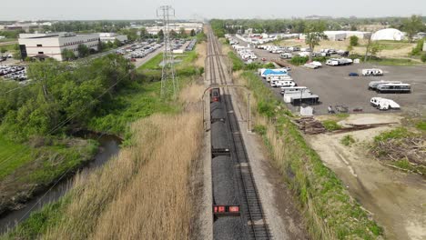 Coal-cargo-wagons-on-train-rails-for-mineral-support,-aerial-establishing-view