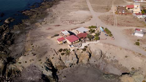 Aerial-slow-orbit-around-Mexican-coastal-villa-house-on-top-of-sea-cliff