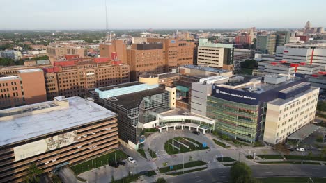 Aerial-tucking-shot-of-the-Harper-University-Hospital-during-golden-hour-showing-a-stunning-skyline-of-Detroit-City