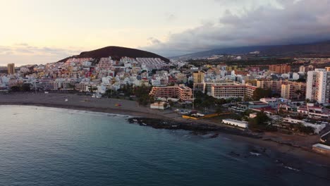 Scenic-aerial-establisher-of-town-of-Los-Cristianos-in-Canary-island,-day