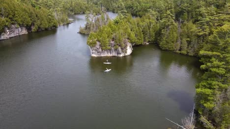 Drone-flying-towards-kayakers-paddling-on-a-lake-in-Guelph