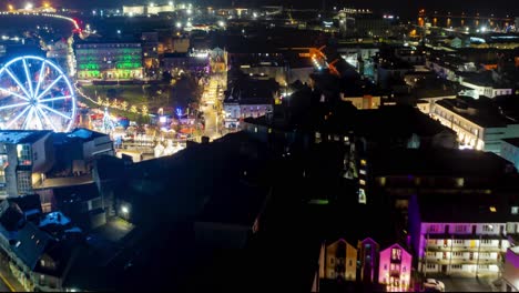 Aerial-serene-hyperlapse-over-Eire-square,-Galway-Christmas-market,-Ireland-at-night