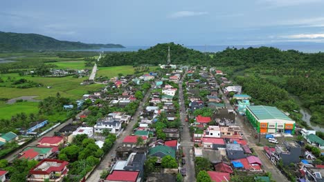 Establishing-Aerial-View-of-Idyllic,-Tropical-Town-within-lush-jungle-outskirts-of-Catanduanes,-Philippines