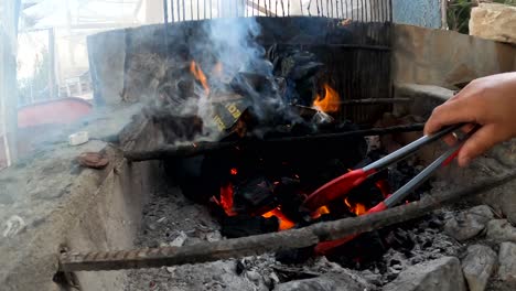 Charcoal-fire-is-set-ablaze-on-rebar-and-concrete-stove-area