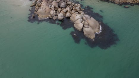 Drone-aerial-pan-up-over-beautiful-light-blue-beach-and-white-rocks-on-a-sunny-day-in-Wilsons-Promontory