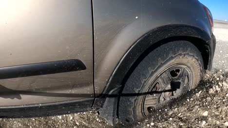 Close-up-of-SUV-breaking-through-muddy-playa-mud-and-dirt-epic-offroading