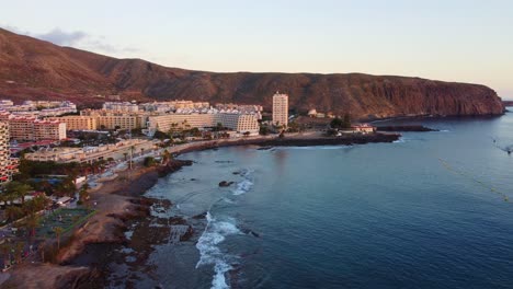 Establisher-aerial-shot-of-Los-Cristianos-coastal-town-in-Tenerife,-forward